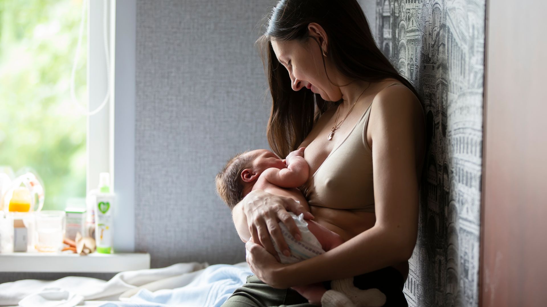 A parent breastfeeding an infant 