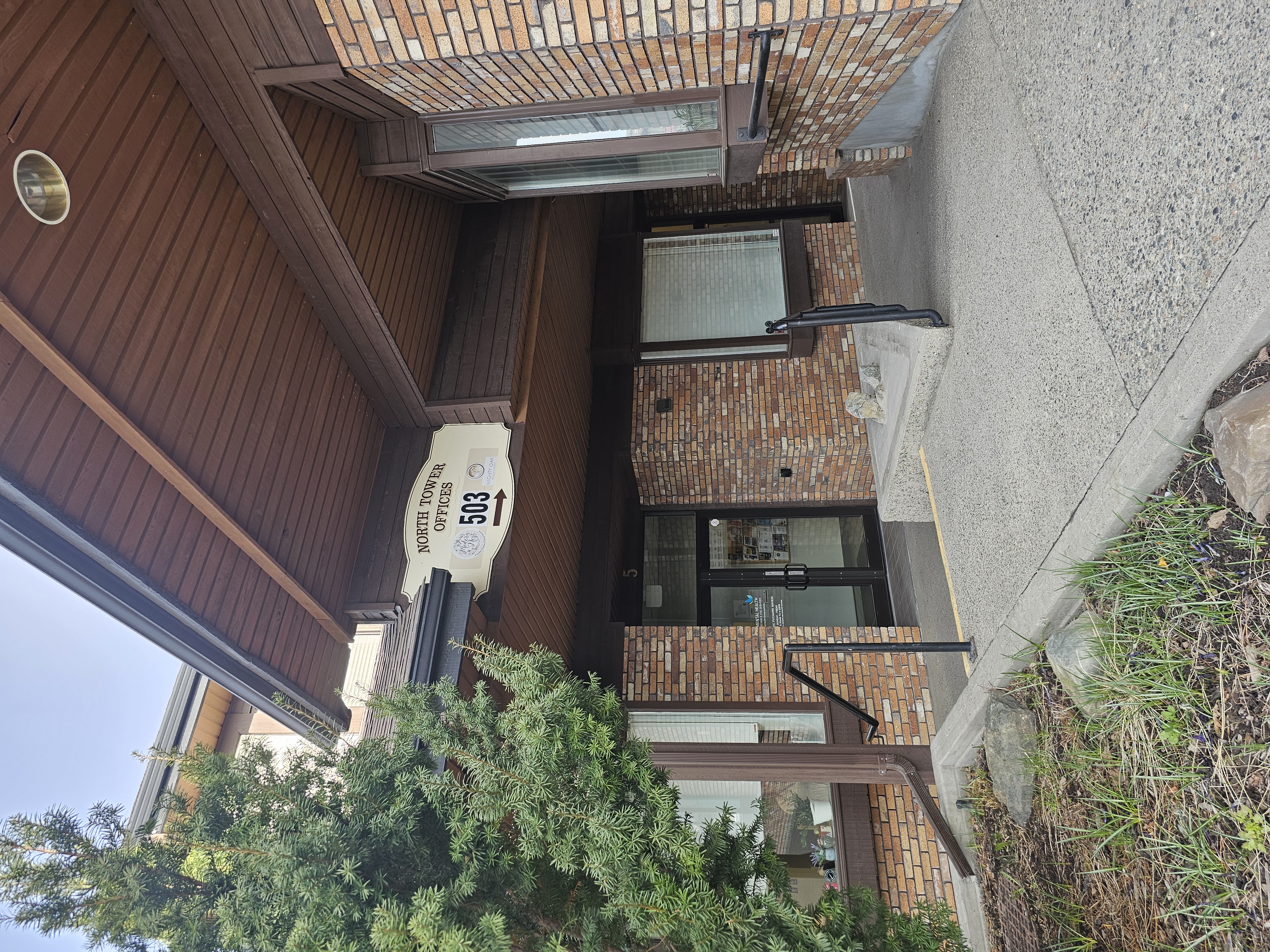 The front doors of a building surrounded by brick walls.