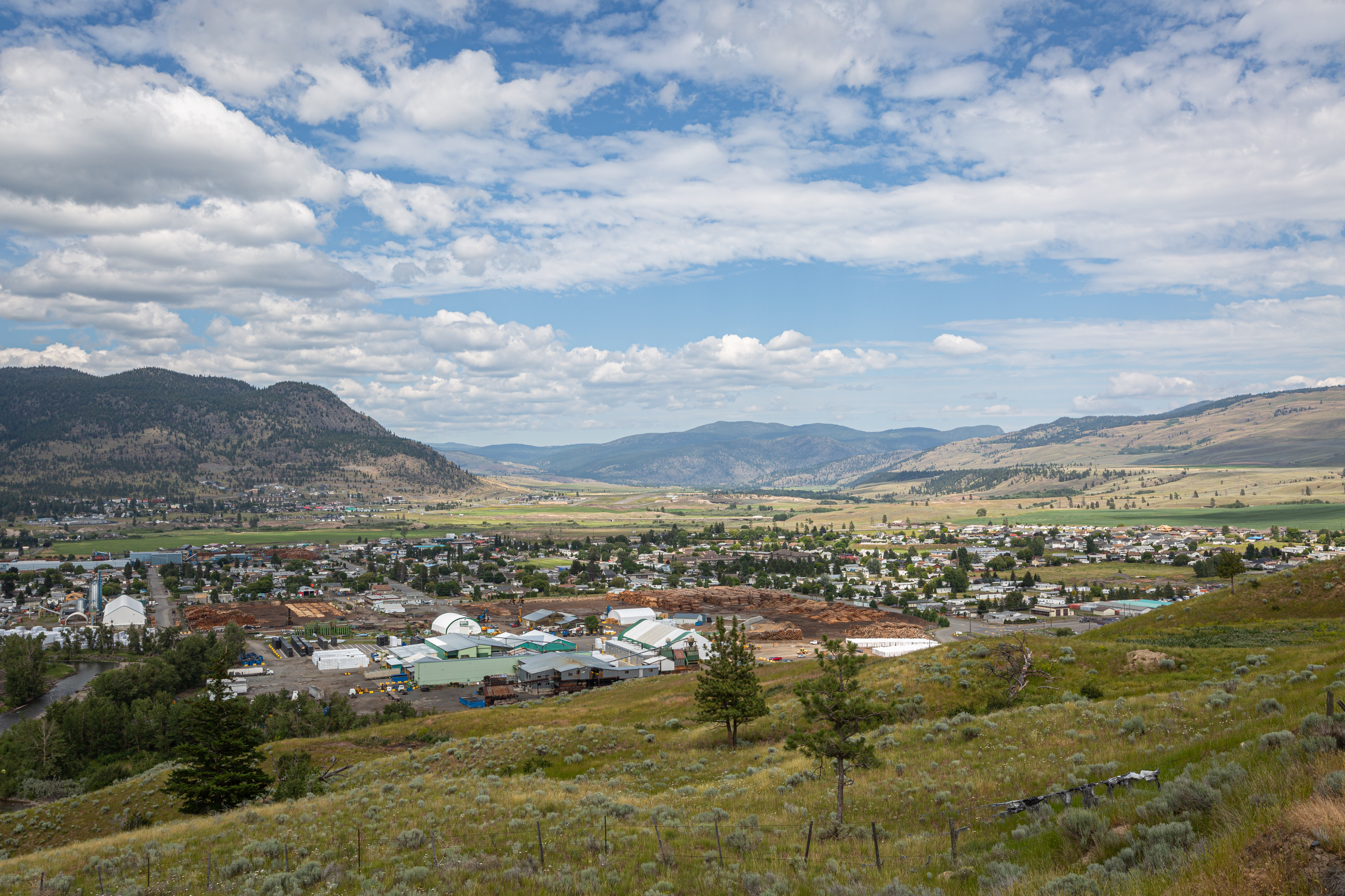 A landscape shot of a city surrounded by mountains.