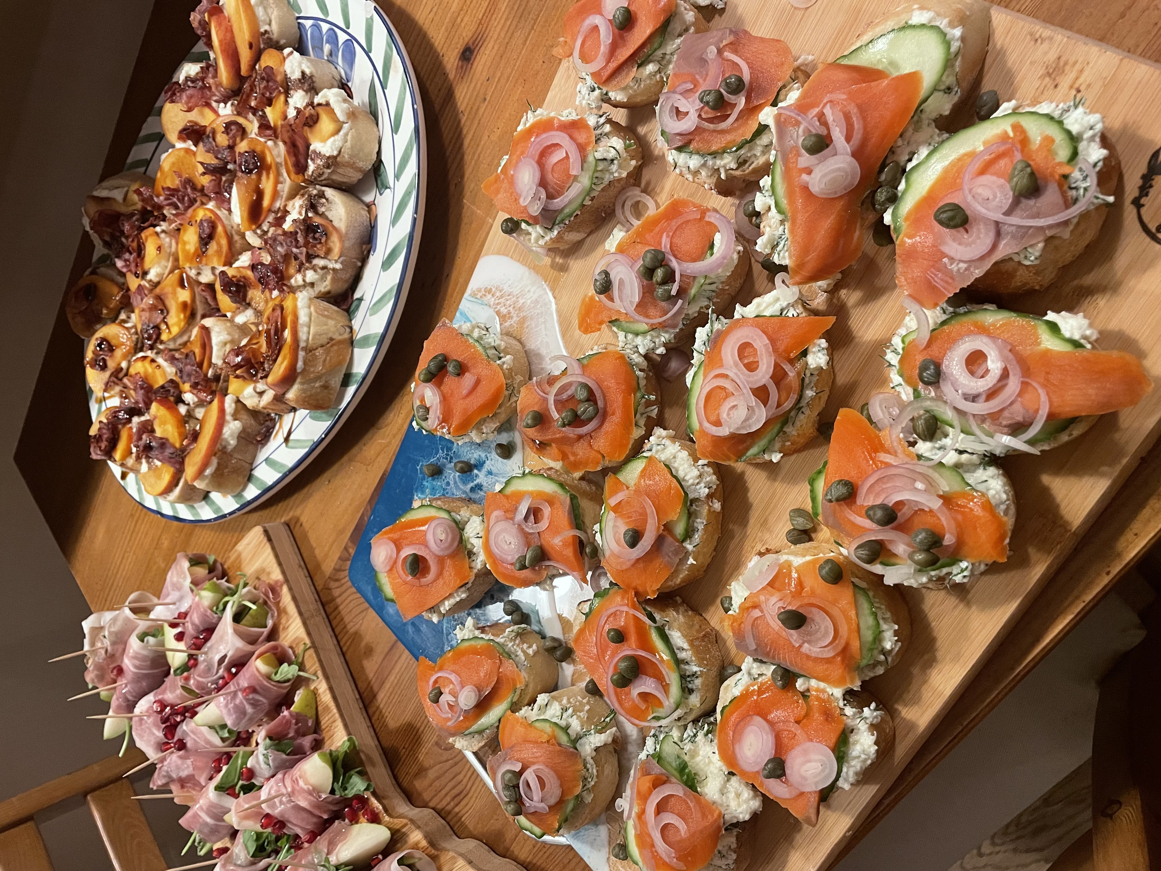 An assortment of appetizers displayed on cutting boards and a plate.