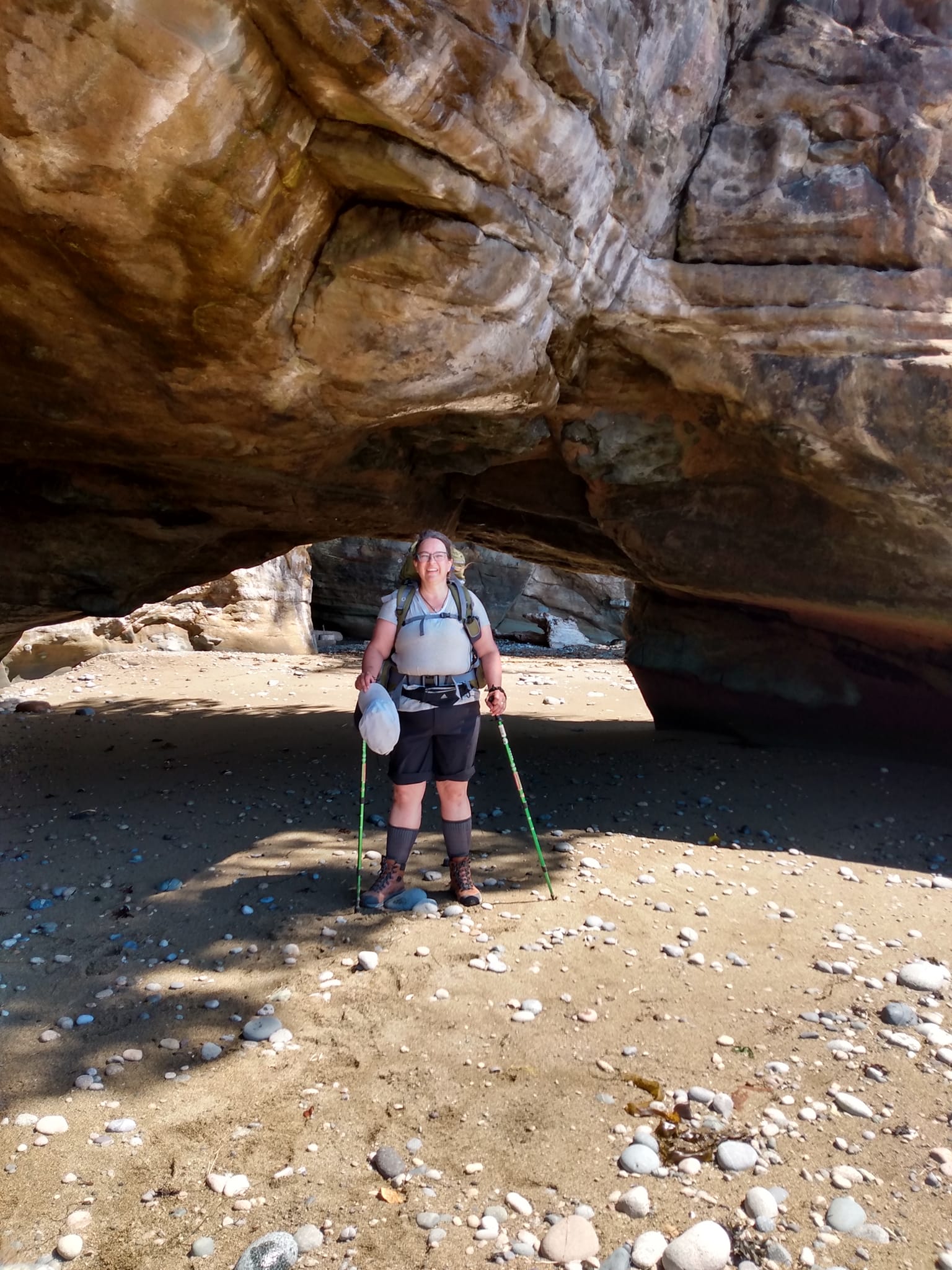 Woman with backpack in the sand. 