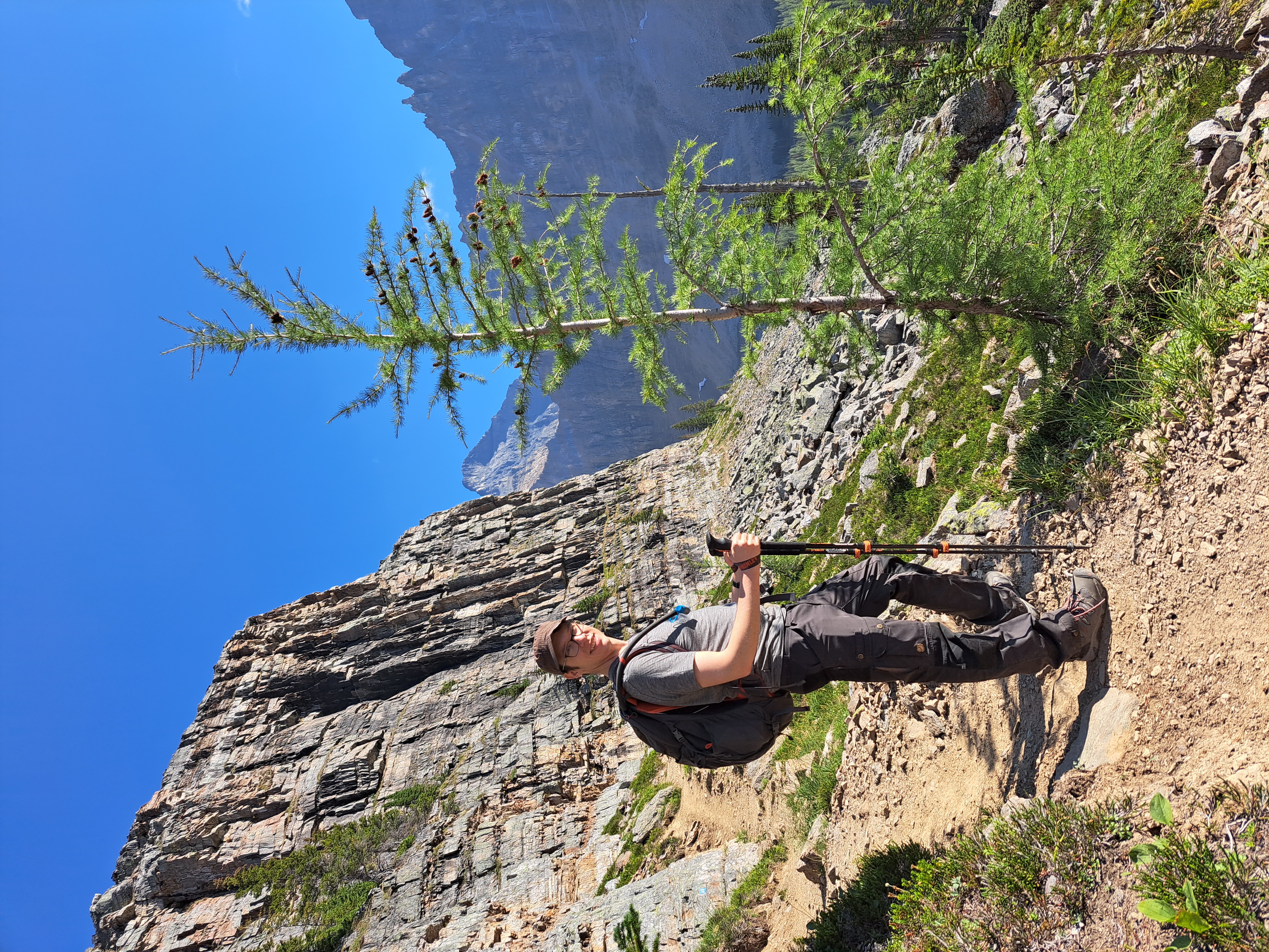 Man hiking on rocky path with mountain in background