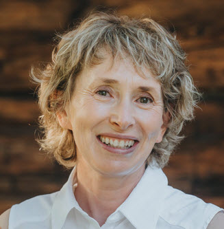 Headshot of a woman with blonde, short hair smiling