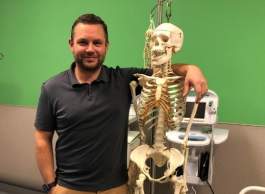 Dr. David Cruickshank posing with skeleton