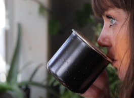 Jessica, who provides peer support through Integrated Treatment Teams, drinks a cup of coffee