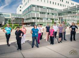 Microbiology and PCR staff posing with Dr. Bonnie Henry shirts outside of the lab in front of KGH