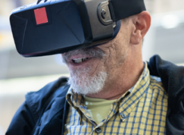 Senior man wears a virtual reality headset.