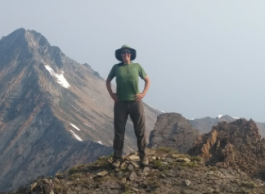 Dr. Ilona Hale standing on a mountain.