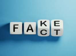 A set of four dominoes that reads both "fake" and "fact."