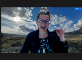 A person holds up a harmonica on a Zoom call.