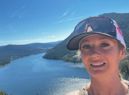 Kayleigh captures her mountain hike with a selfie photo of Paul Lake in the background.