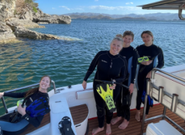 A Mom and her three children on a boat in Costa Rica about to go snorkelling