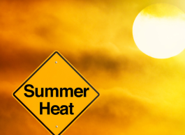 A sign that says summer heat in front of a hazy yellow sky and sun