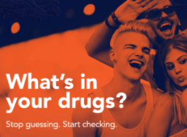 A selfie of four people against an orange background with text overlay what's in your drugs? Stop guessing. Start checking.