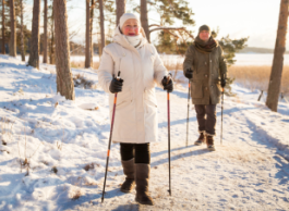 Two individuals are outside for a walk in the winter