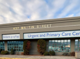 A beige building with a white sign that says Urgent and Primary Care Centre