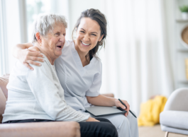 home care worker smiling with her senior patient