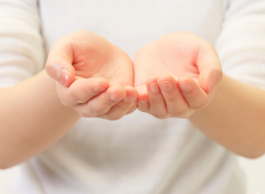 Close-up of an individual's open hands held together, palms facing upward.